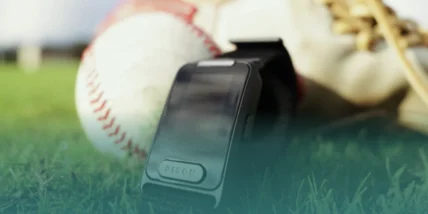 an image of the Pison baseball wearable in a field with a baseball